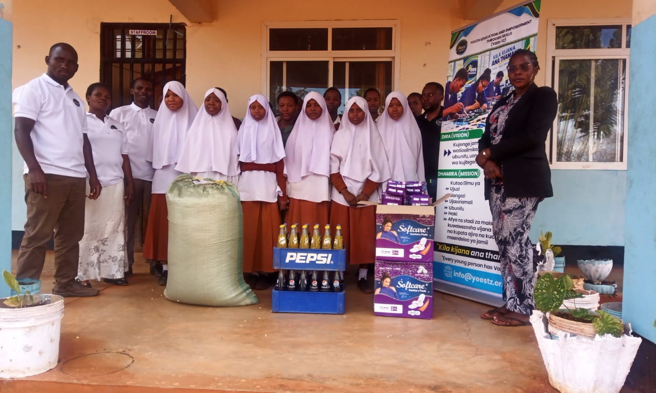 Participants and organizers pictured with activity materials during a YEES TZ programme activity.
