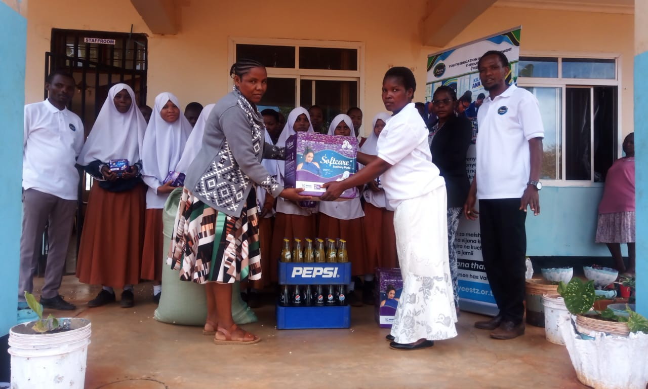Presentation of activity materials with participants gathered in the background.