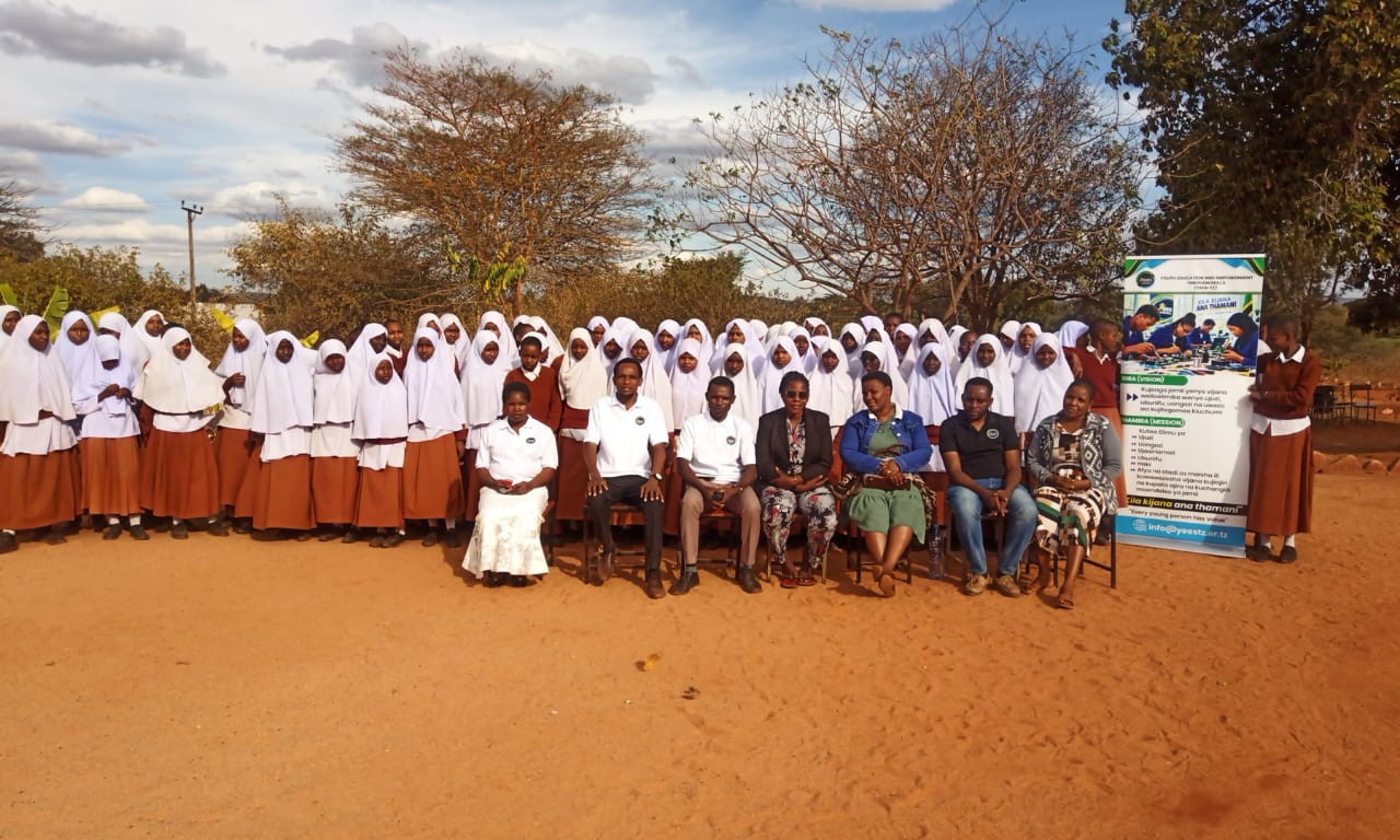 Group photograph of participants in school uniform with YEES TZ organizers.